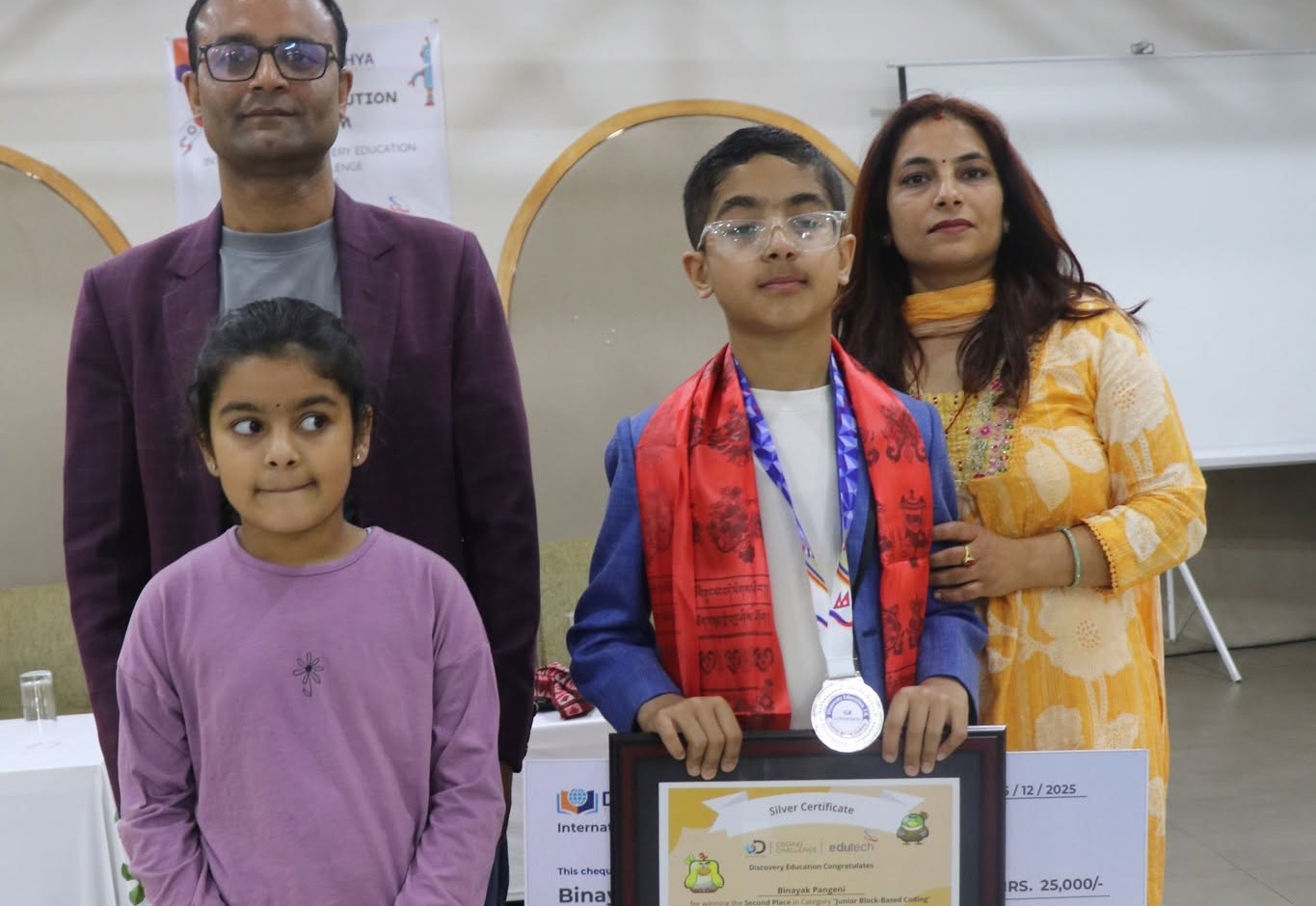 Nepali parents celebrating their child’s achievement and participation
