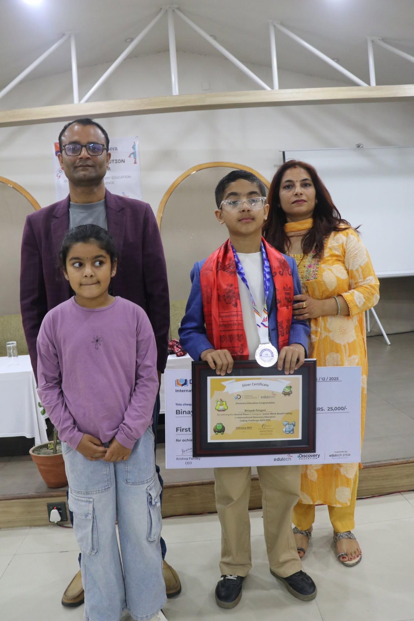 Student award recipient posing with family and certificate