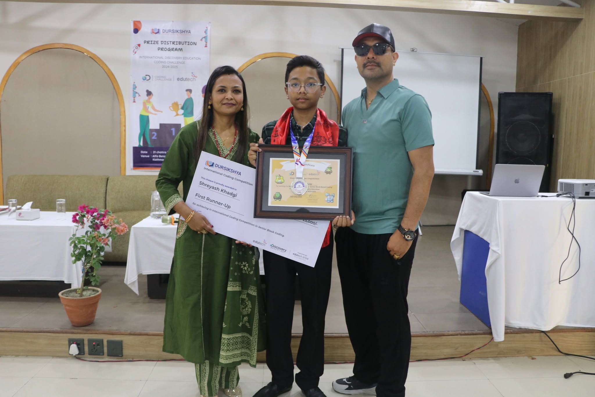 Student winner with certificate, medal, and family during prize distribution